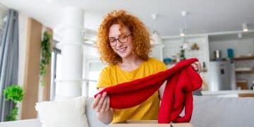 Young woman receiving parcel at home. Holiday shopping online and unpacking cardboard box. Delivery service during covid quarantine. Happy girl getting gift. Lifestyle moment